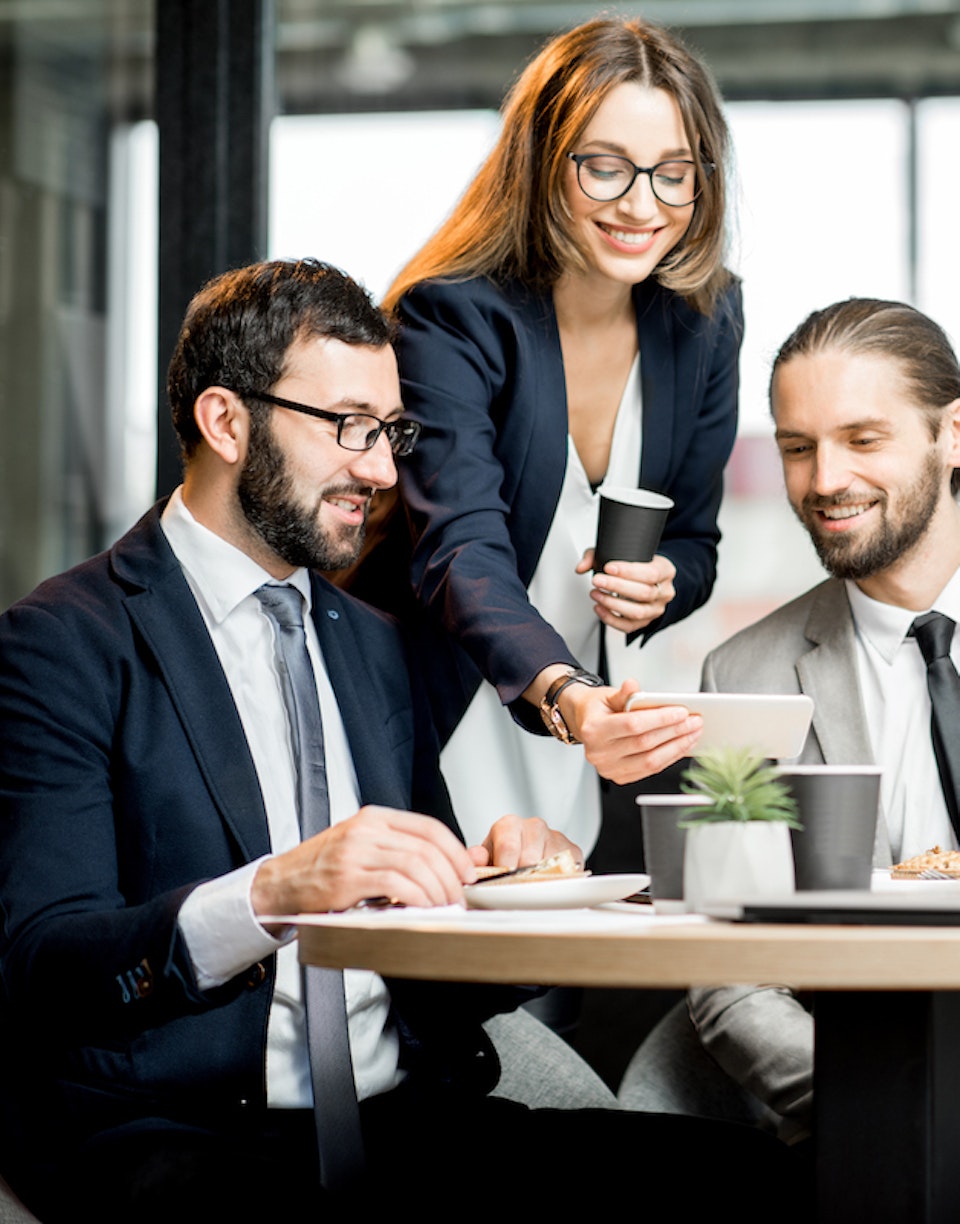 Personas mirando un smartphone mientras toman café